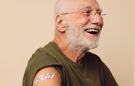 man smiling after getting covid shot